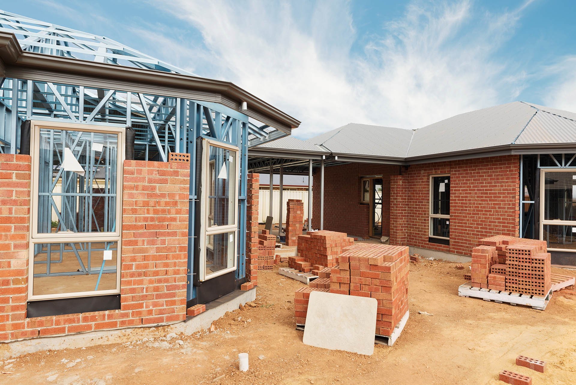 New,Residential,Construction,Home,From,Brick,With,Metal,Framing,Against